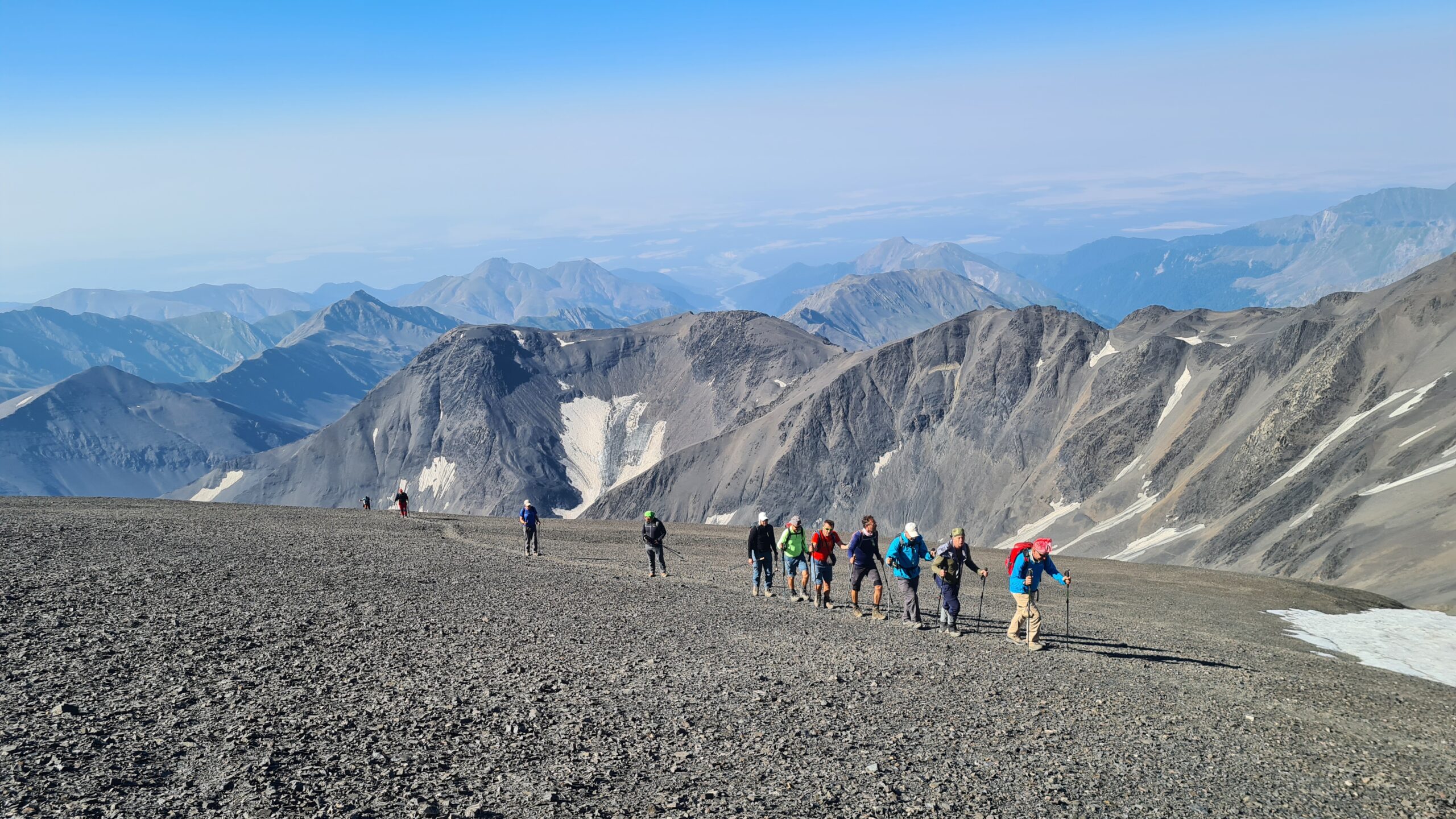 A group of hikers crossing high scree on the way to Bazarduzu, Azerbaijan