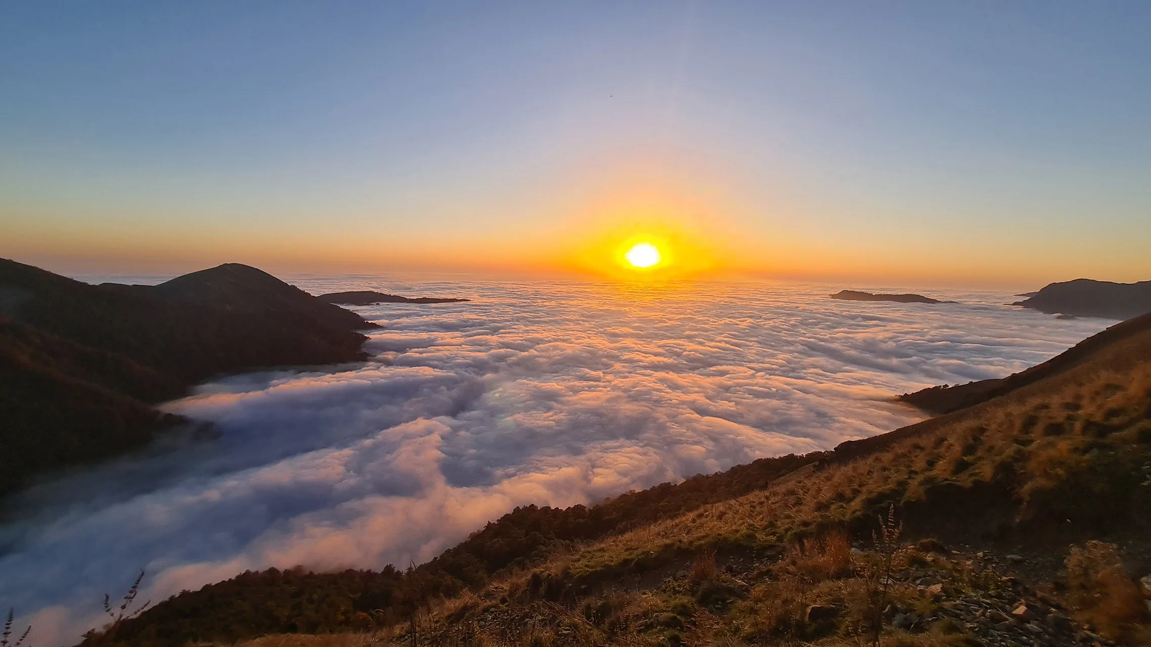 Sunset over a sea of clouds seen from a mountain ridge in Azerbaijan