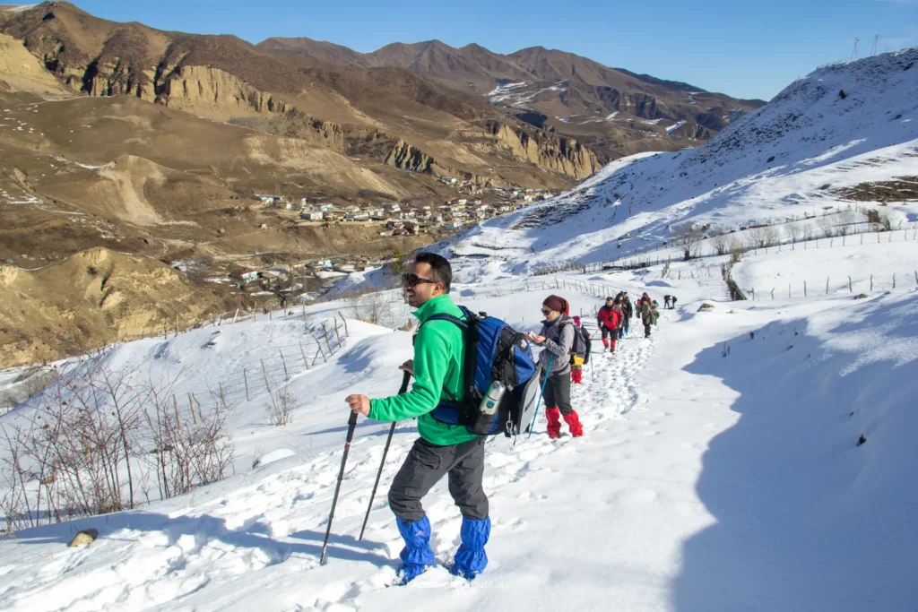 Hiker crossing a snowy slope in the Greater Caucasus