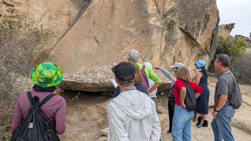 Group exploring the petroglyph rocks of Gobustan National Park