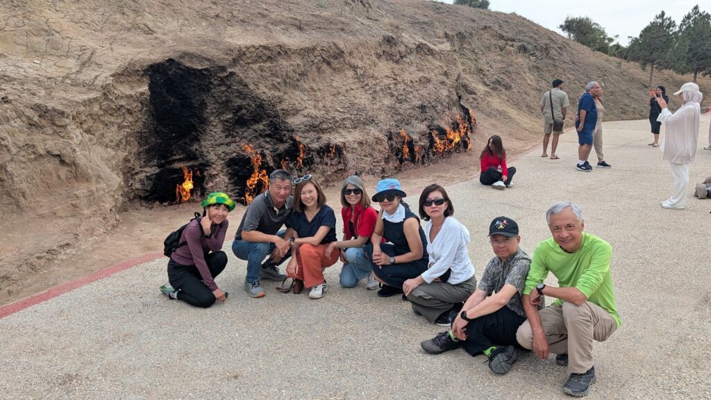 Group standing in front of the natural gas flames of Yanardag on the Absheron Peninsula